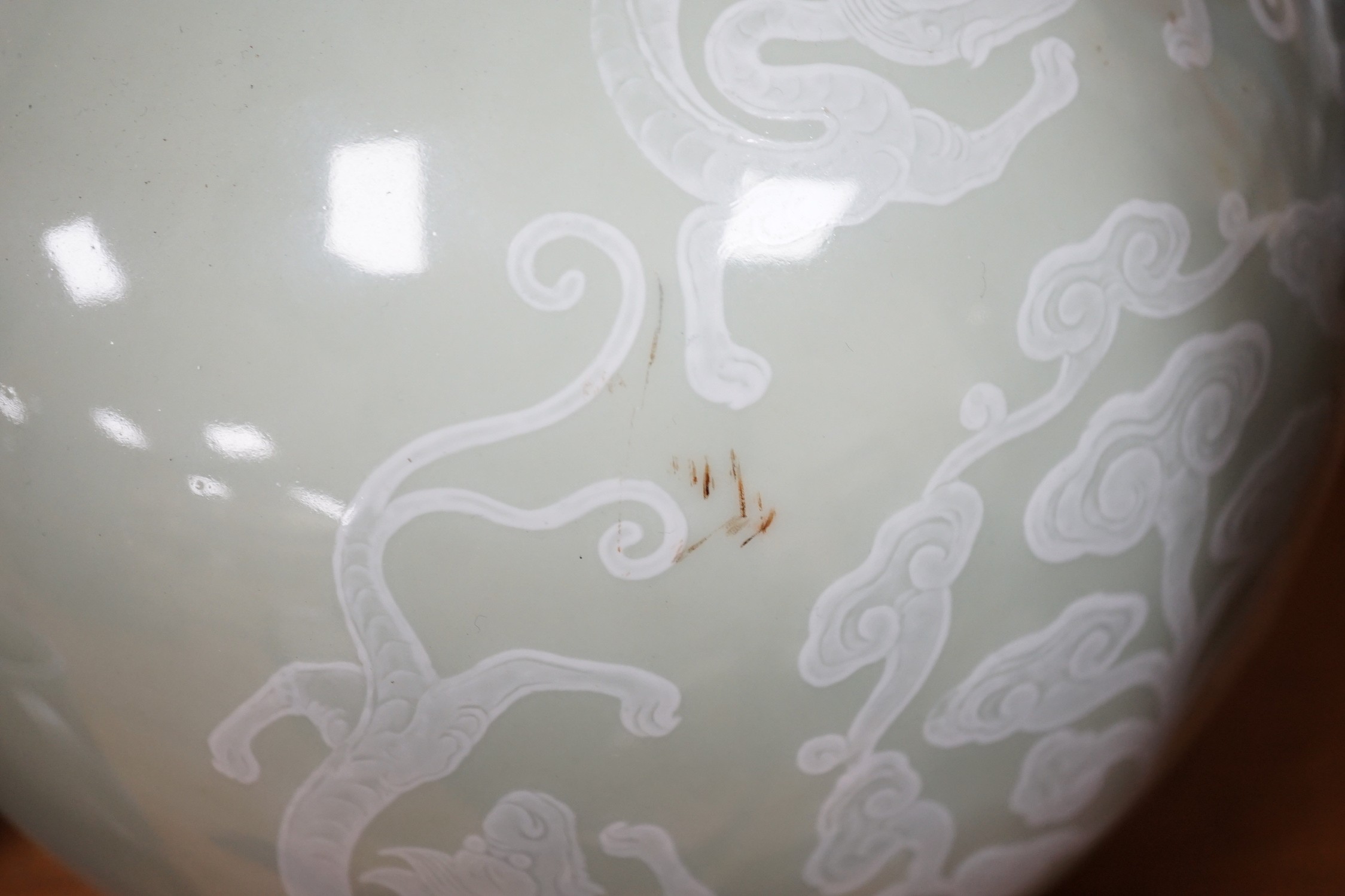 A pair of Chinese white slip decorated celadon glazed bottle vases, mid 20th century, 39cm